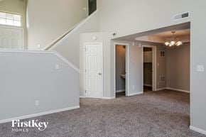 Indianapolis house for rent - the upstairs bonus room has carpeted flooring and a staircase
