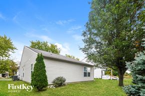 Zionsville house for rent - A house with a lawn and trees in front of it.