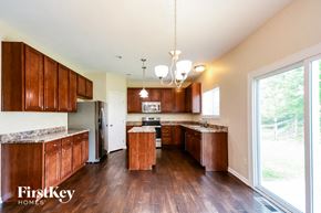 Morrow house for rent - a kitchen with wooden cabinets and a large window