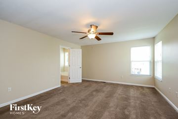 Morrow house for rent - a living room with carpet and a ceiling fan