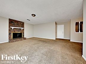 Memphis house for rent - A room with a fireplace and a carpeted floor.
