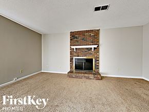Memphis house for rent - A room with a fireplace and carpeting.