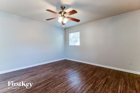 Tampa house for rent - a living room with a ceiling fan and wood floors