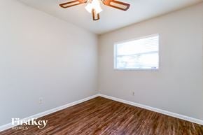 Tampa house for rent - a bedroom with white walls and wood floors and a window