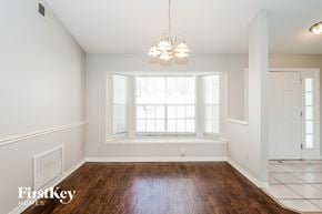 Orlando house for rent - A room with a wooden floor and a large window.