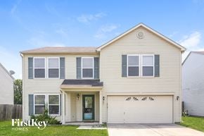 Mccordsville house for rent - a beige house with a white garage door