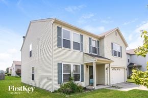 Mccordsville house for rent - a white house with white siding and a white garage
