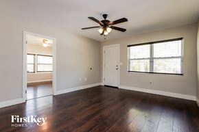 New Port Richey house for rent - an empty living room with a ceiling fan and a window