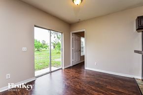 North Port house for rent - a living room with a door to a hallway and a wood floor