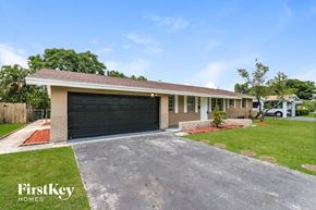 Plantation house for rent - A house with a garage and a driveway in front of it.