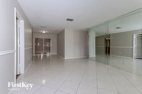 Plantation house for rent - A spacious room with a glass wall and tiled floor.