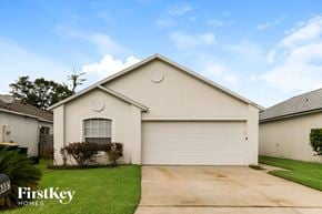 Jacksonville house for rent - A house with a white garage door and a logo that says "FirstKey Homes".