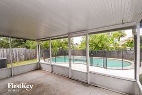 Jacksonville house for rent - A pool in a backyard with a FirstKey Homes logo.