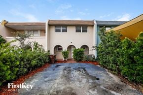 Hialeah house for rent - a house with a driveway in front of it