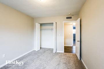 Hialeah house for rent - a bedroom with a closet and a door to a hallway