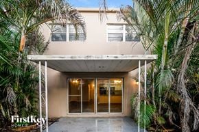Hialeah house for rent - the front of a house with palm trees