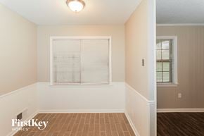 Bartlett house for rent - the living room of a home with a large window and wooden floors