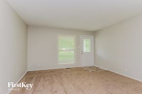 Indianapolis house for rent - A room with a carpeted floor and two doors, one of which is open.