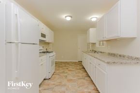 Indianapolis house for rent - A kitchen with white appliances and cabinets.