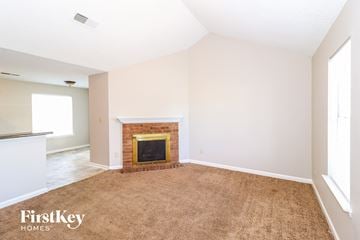 Cordova house for rent - a living room with a brick fireplace and a carpet