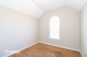 Cordova house for rent - a bedroom with white walls and carpet and a window