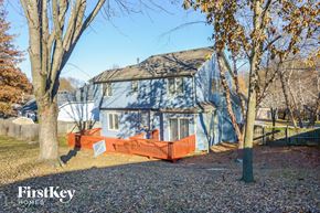 Parkville house for rent - a blue house with a red fence and trees