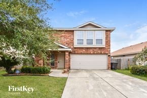 San Antonio house for rent - a small brick house with a white garage door