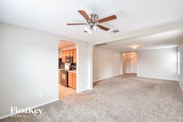 San Antonio house for rent - a living room with carpet and a ceiling fan