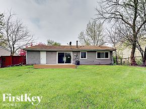 Hanover Park house for rent - a small house in a grassy yard with a wood deck