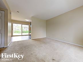 Hanover Park house for rent - an empty living room with a door to a patio