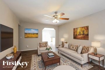 Peoria house for rent - A living room with a couch, a coffee table, and a painting on the wall.