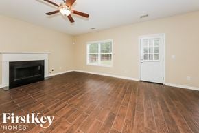 Atlanta house for rent - the living room with wood floors and a fireplace