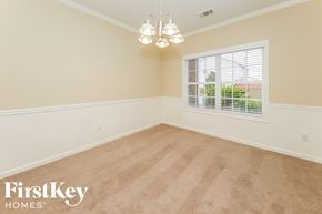 Atlanta house for rent - a empty dining room with a window and a chandelier