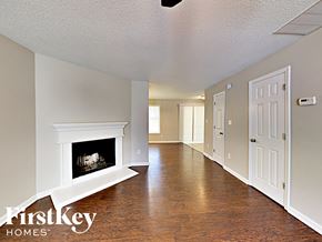 Lithonia house for rent - a living room with a fireplace and a hallway with a door