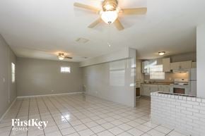 Pinellas Park house for rent - an empty living room and kitchen with a ceiling fan