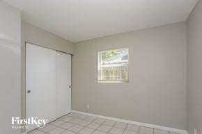 Pinellas Park house for rent - a bedroom with a door to a closet and a window