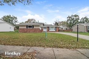 Naperville house for rent - the front of a house with a yard and a sidewalk
