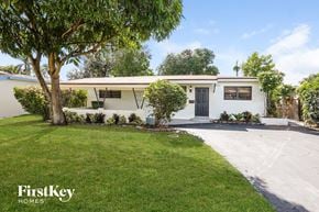 Pembroke Pines house for rent - a white house with a yard and a tree