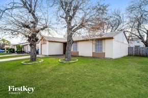 Fort Worth house for rent - the front of a house with two trees in the yard