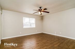 Fort Worth house for rent - the living room with wood floors and a ceiling fan