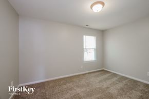 Charlotte house for rent - a bedroom with white walls and carpet and a window