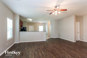 Baytown house for rent - A spacious room with a ceiling fan and wooden flooring.