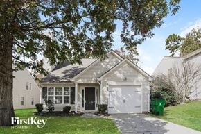 Charlotte house for rent - the front of a white house with a white garage door