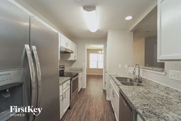 Charlotte house for rent - a kitchen with marble counter tops and stainless steel appliances