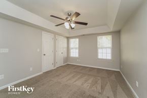 Charlotte house for rent - the spacious living room with ceiling fan and carpeting