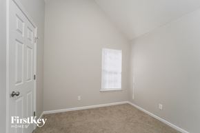 Charlotte house for rent - a bedroom with beige carpet and white walls and a window