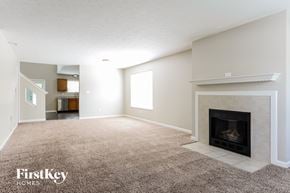 Avon house for rent - A living room with a fireplace and a carpet.