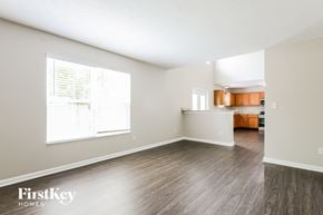 Avon house for rent - A spacious room with wood flooring and a large window.