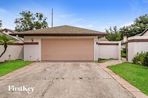 Tampa house for rent - a white house with a garage door and a driveway