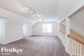 Charlotte house for rent - a bonus room with carpet and white walls and a window